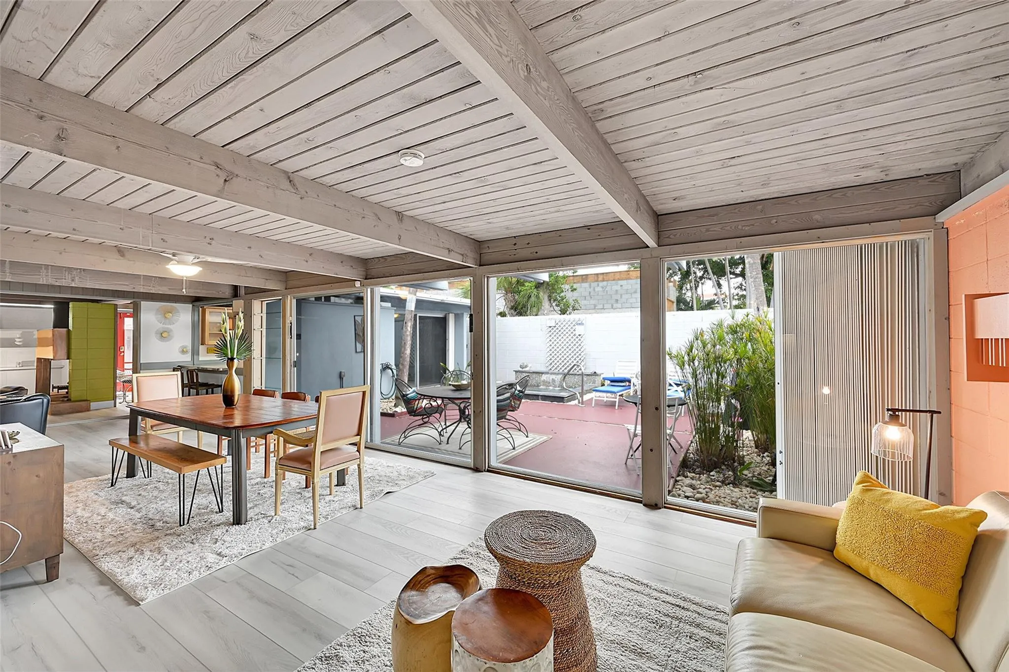 extra living area open to dining area with view of patio