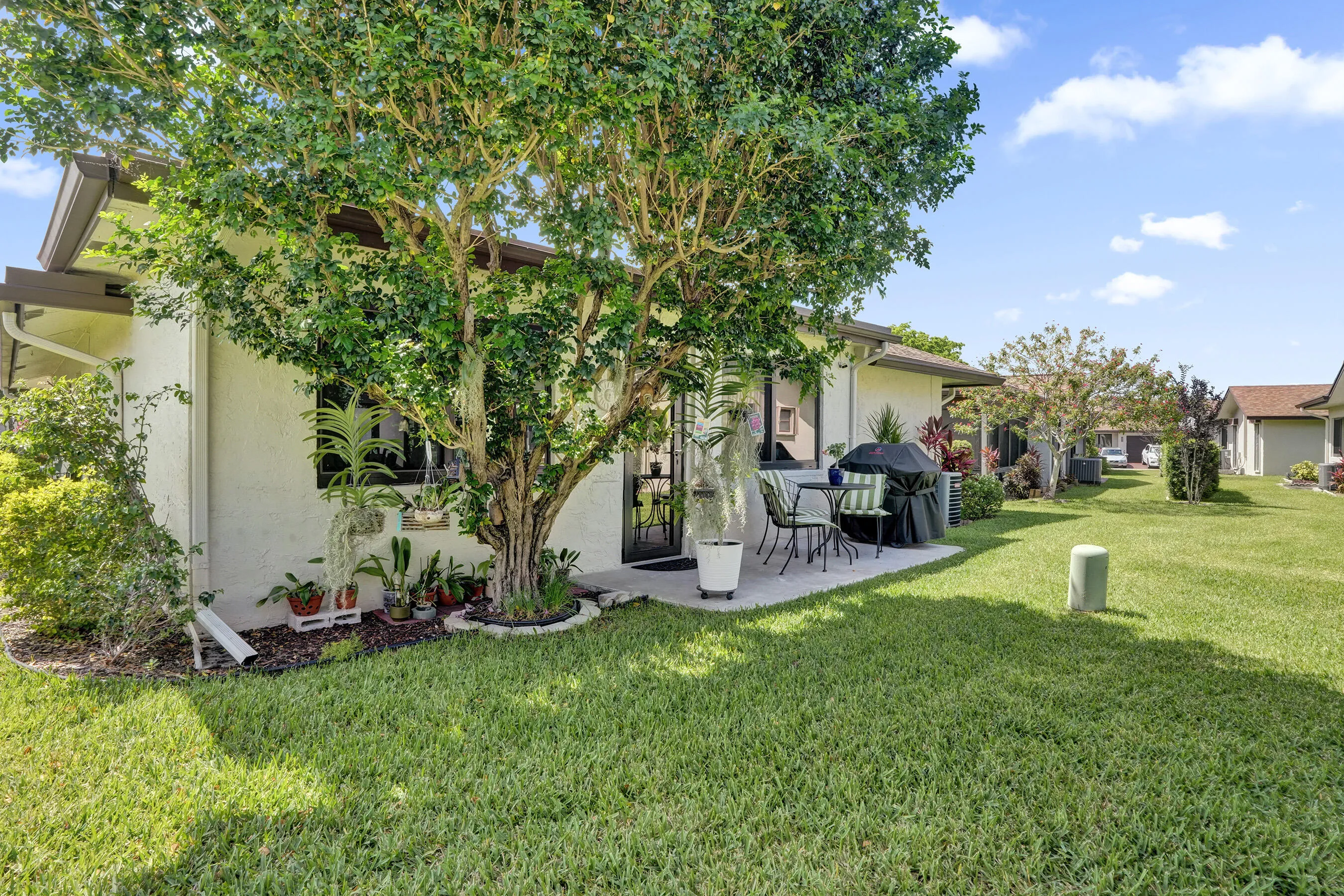 Back of the home,patio and nicely landscaped.