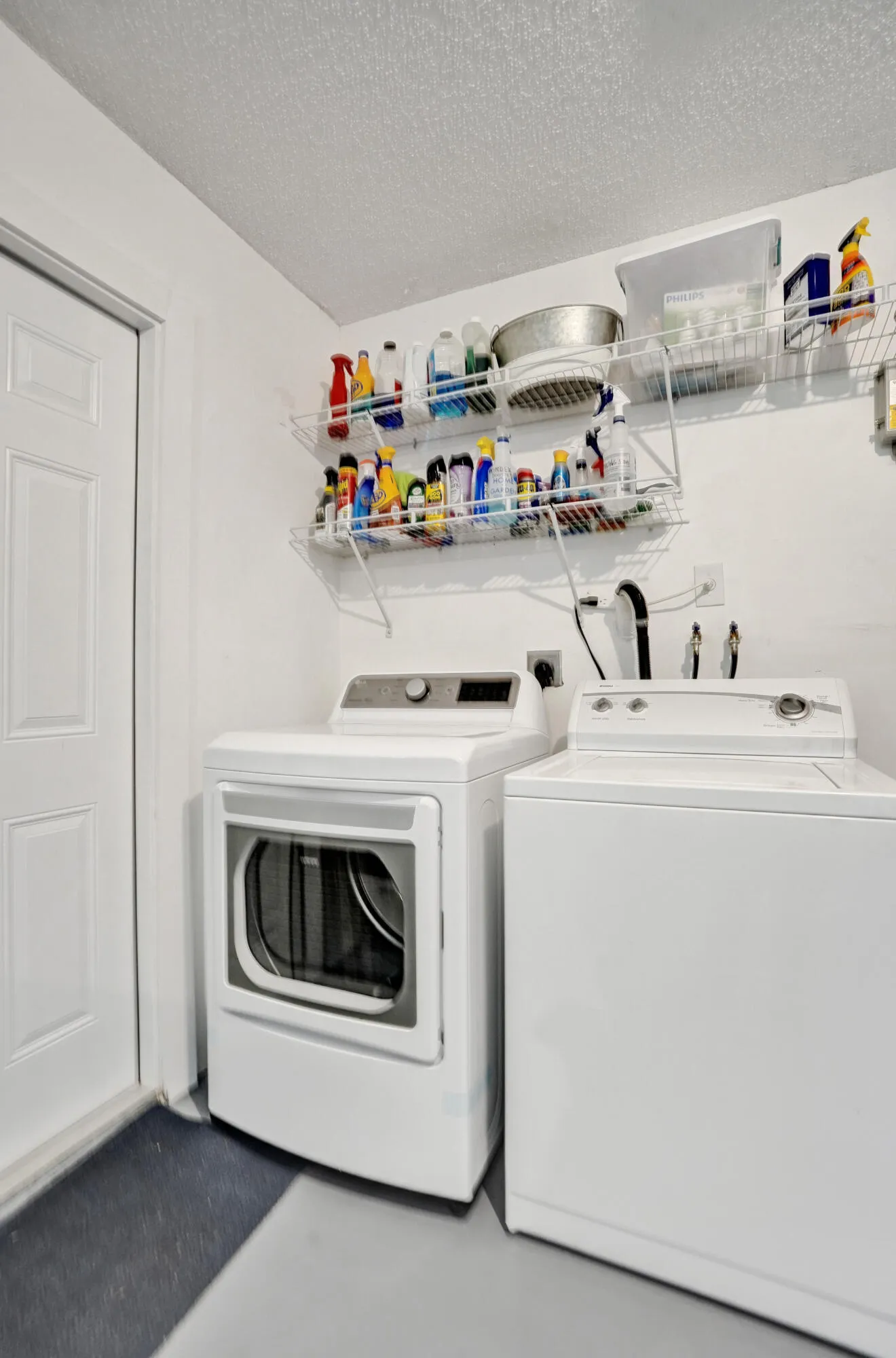 Laundry in the garage with shelving to hold your products