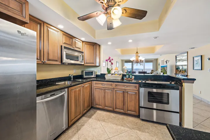 Stainless steel appliances, granite counter tops and tile flooring