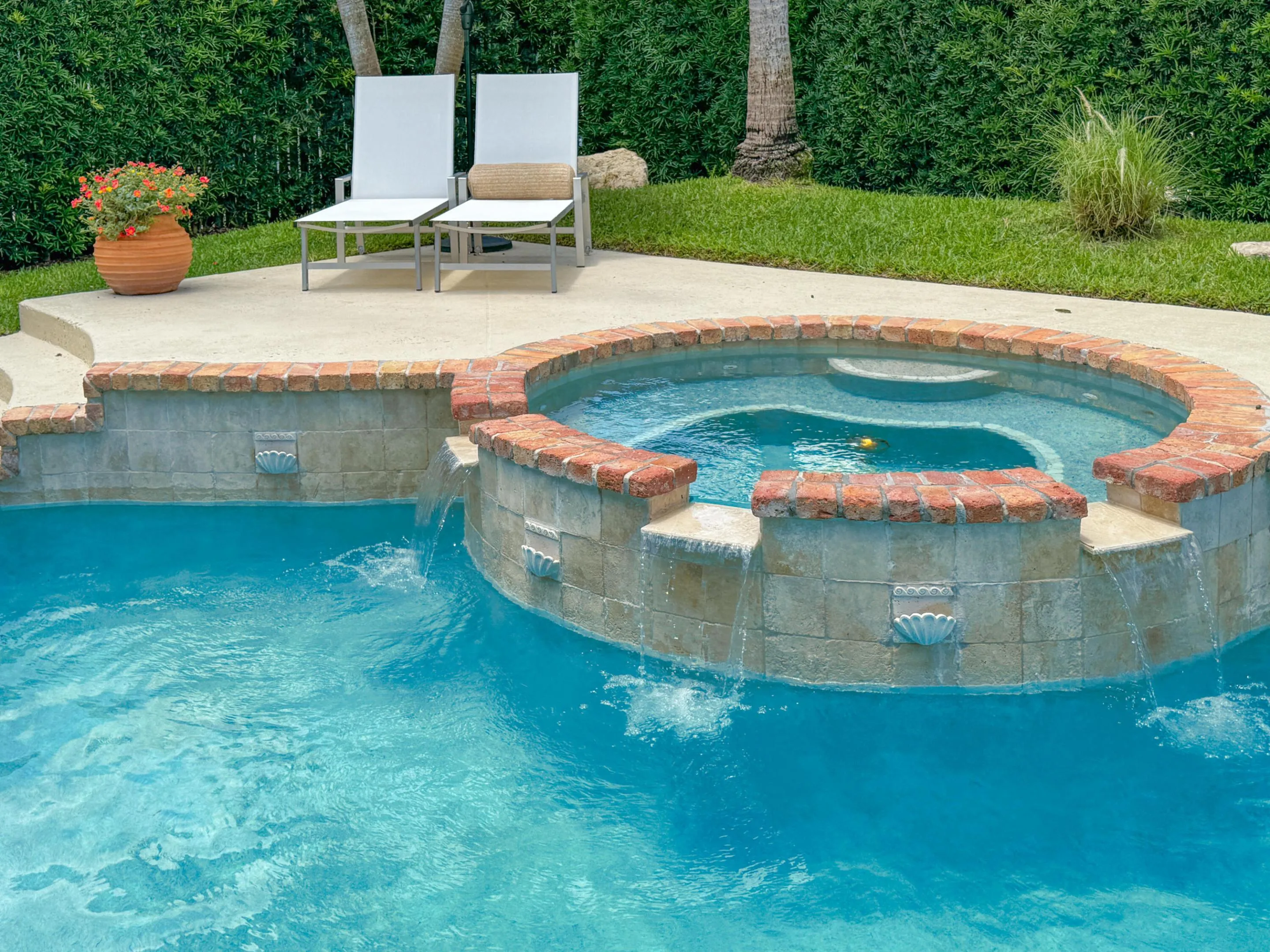 Hot tub with sill over waterfall