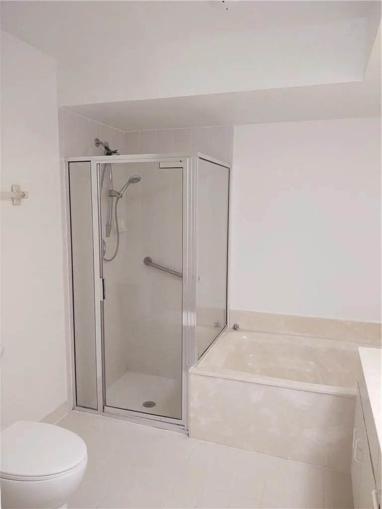 Shower in master bath with soaking tub
