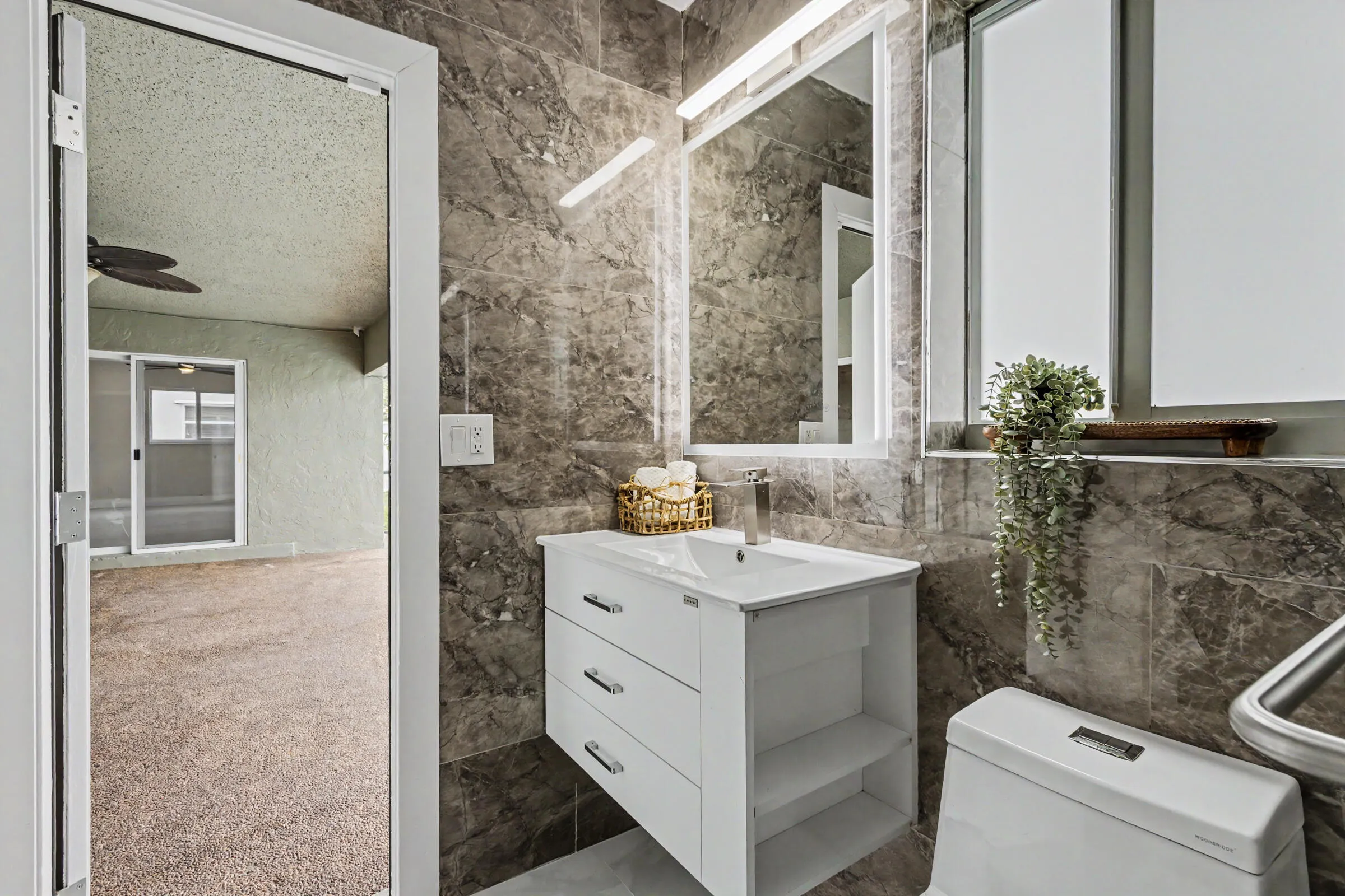 Primary bath serves as a cabana bath with direct access to the patio/pool area.