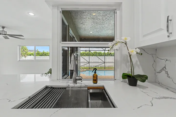deep sink with top of the line disposal and view of the pool