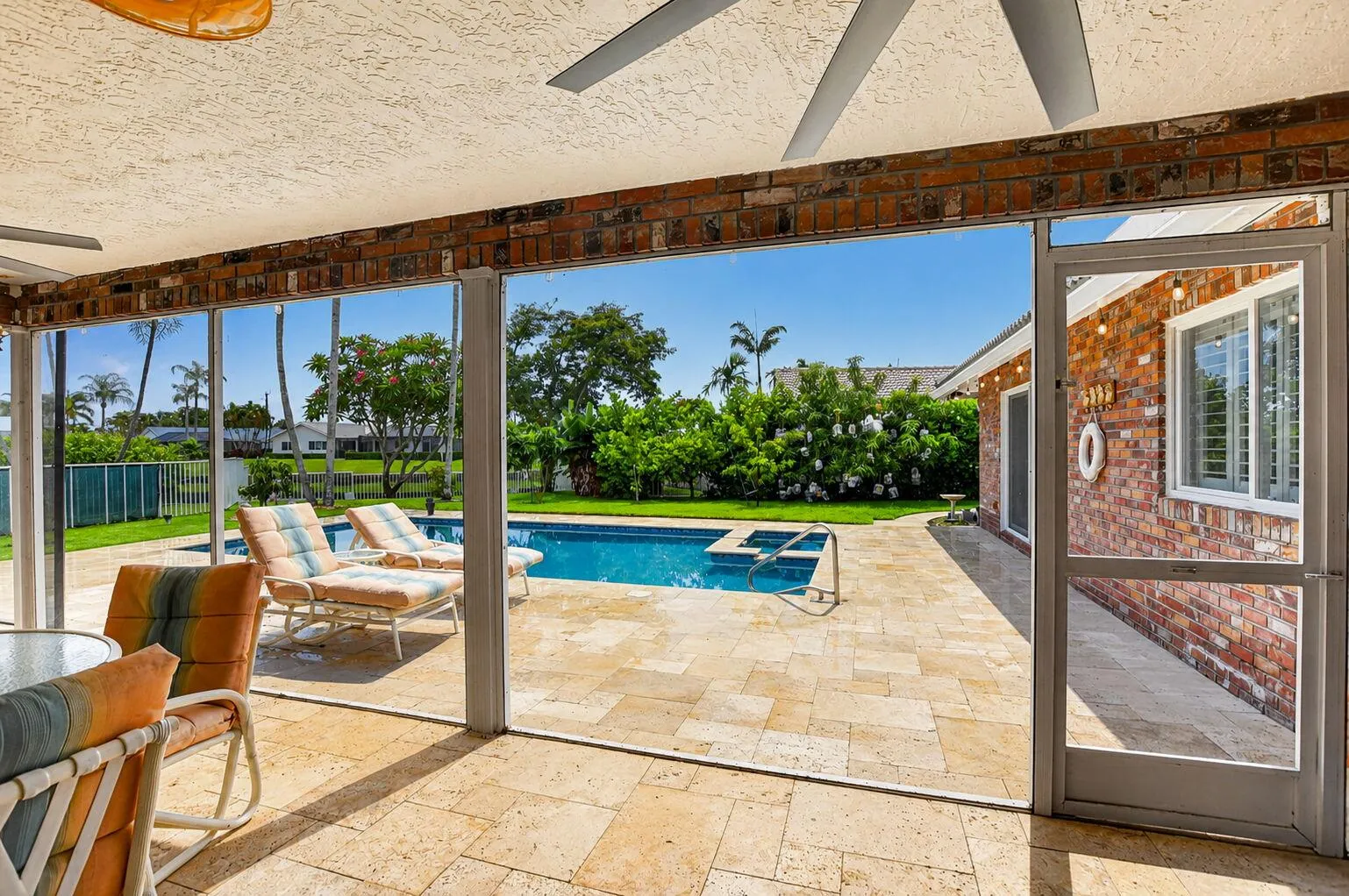 Enjoy morning coffee on your expanded screened patio with travertine floors.