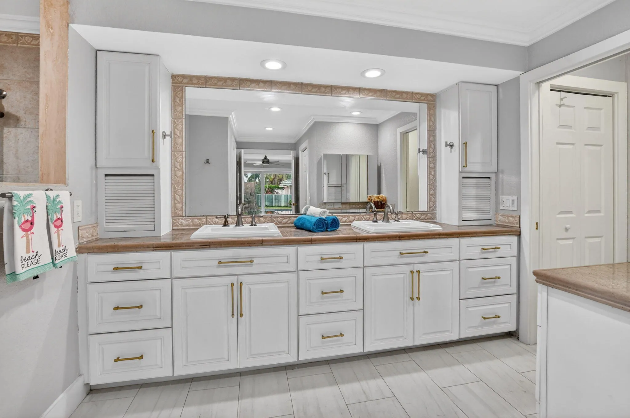 NEW primary bath features a counter height vanity with granite counters and double sinks.