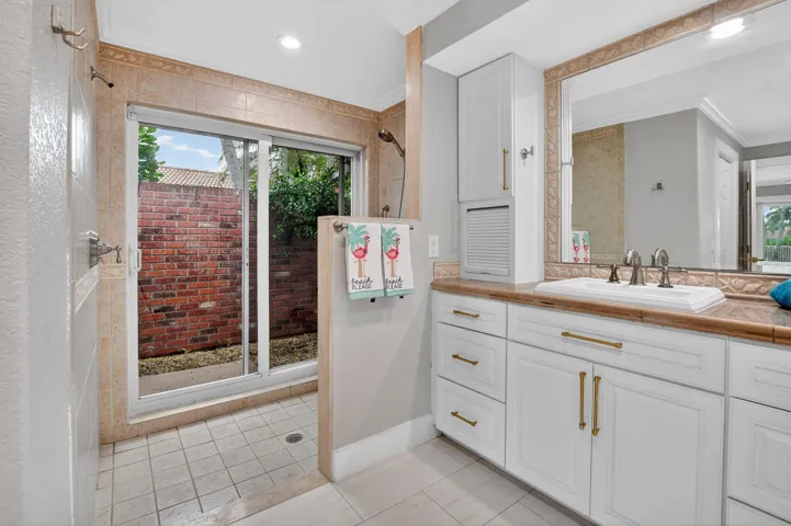 Unwind in yout step-in oversized shower with tile to the ceiling and shell inlays. Enclosed atrium provides privacy.