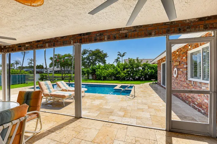 Enjoy morning coffee on your expanded screened patio with travertine floors.