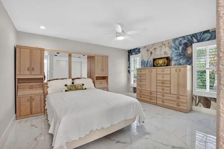 Generous guest bedroom 2 features Plantation shutters and a wall closet with build outs.