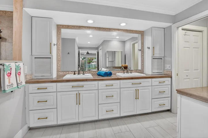 NEW primary bath features a counter height vanity with granite counters and double sinks.