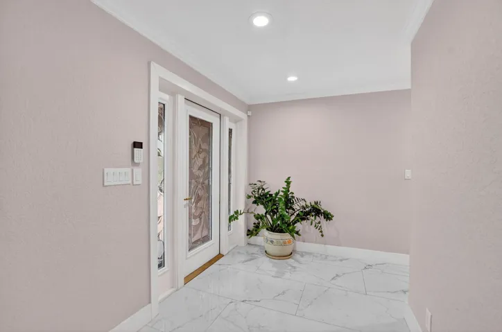 Beveled glass entry door with double sidelights welcomes you to wide-open living areas.