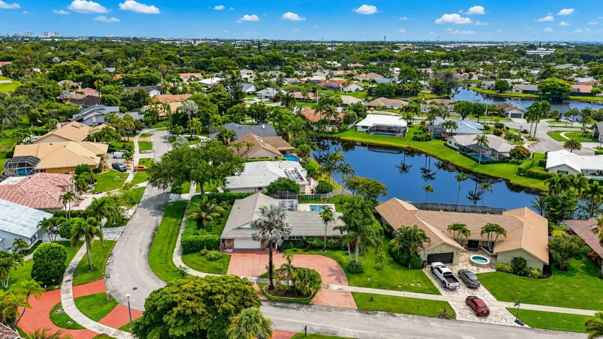 HUGE corner lot with private hedges and long lake views.