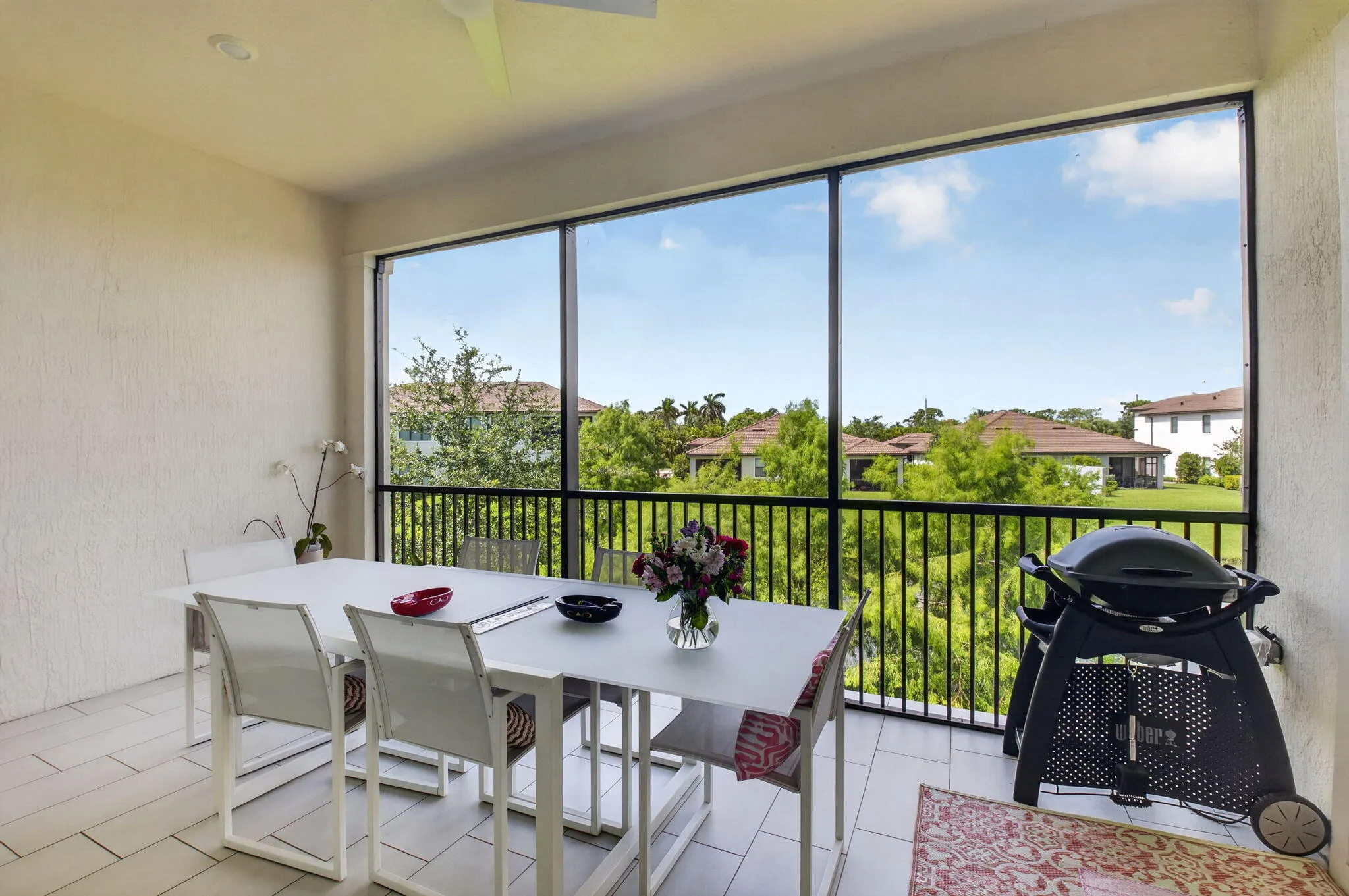 Covered and screened lanai with breathtaking lake views and lush treetops