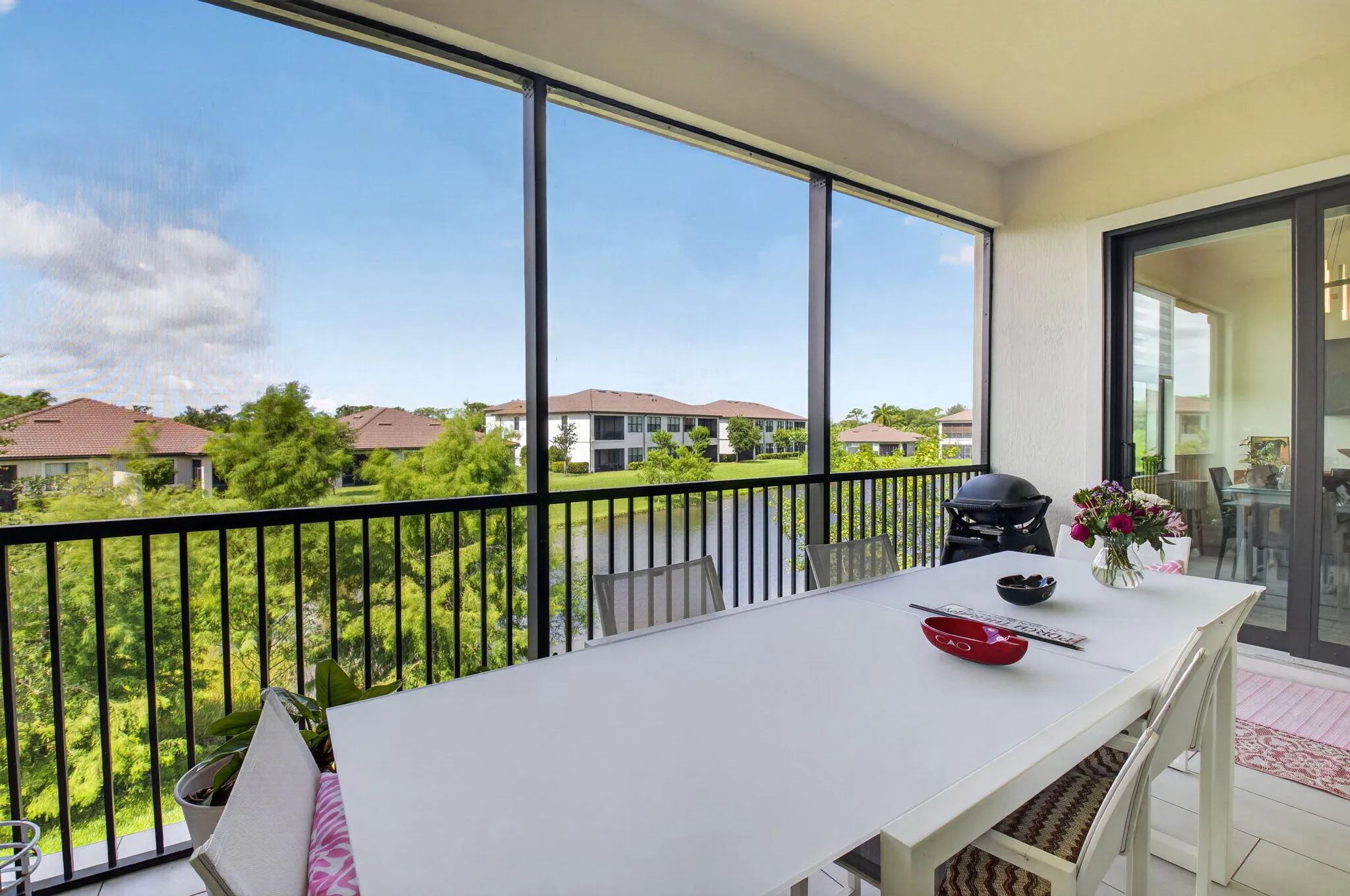 Covered and screened lanai with breathtaking lake views and lush treetops