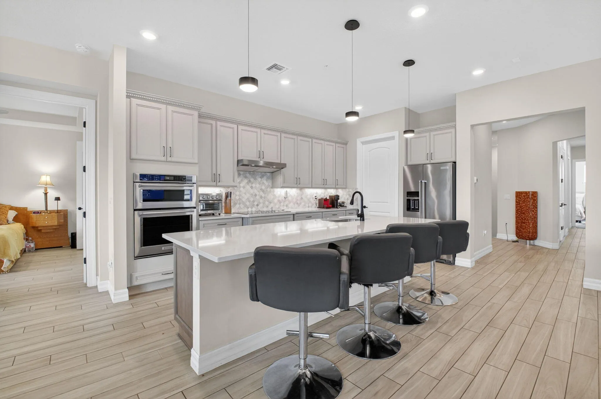 Oversized kitchen with walk-in pantry, 42" cabinets, KitchenAid appliances, quartz countertops, and much more!