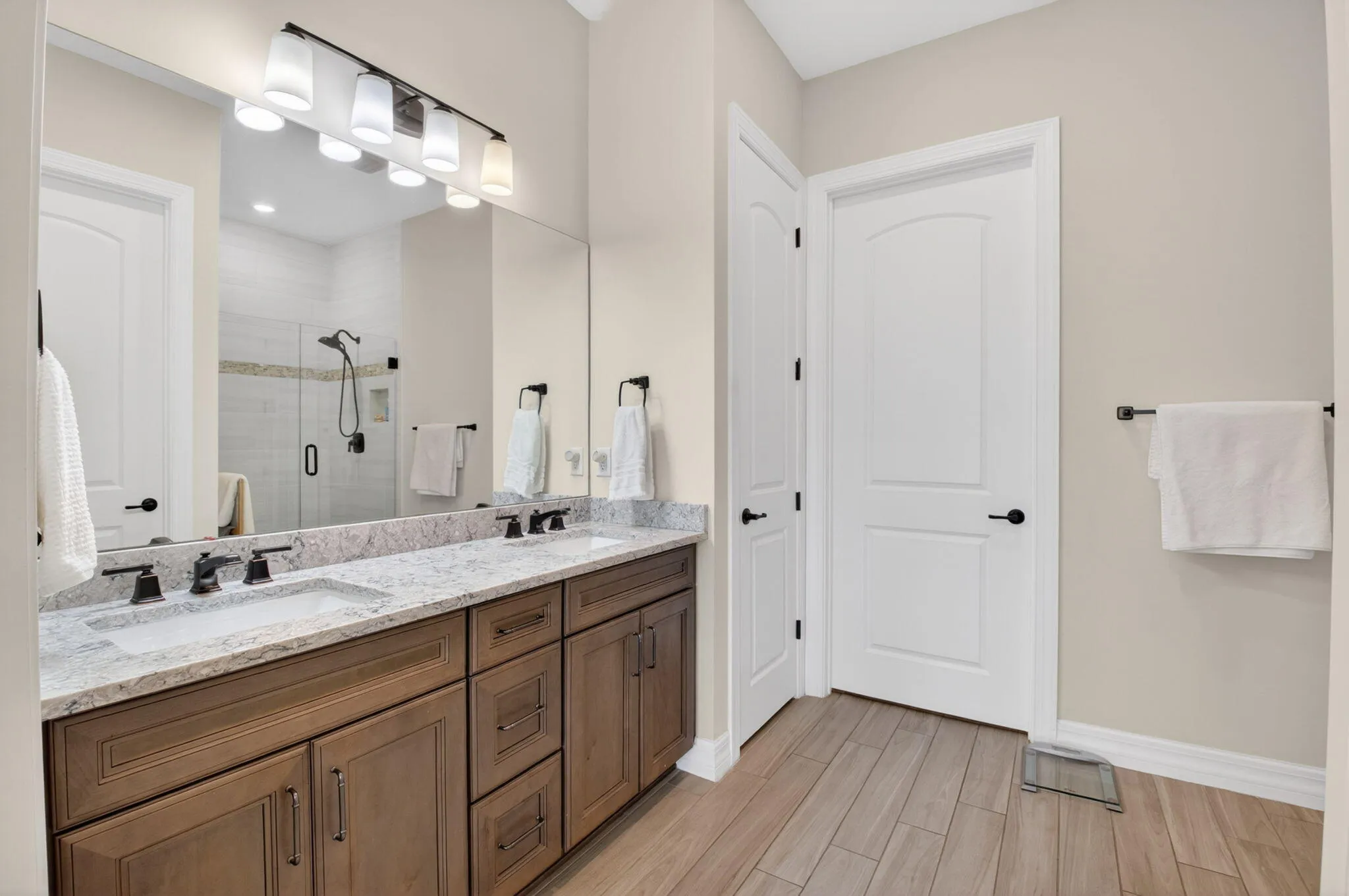 Primary bedroom with trey ceiling, lake views, en suite, and custom walk-in closet.