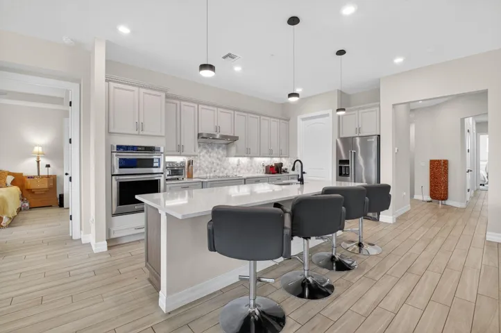 Oversized kitchen with walk-in pantry, 42" cabinets, KitchenAid appliances, quartz countertops, and much more!