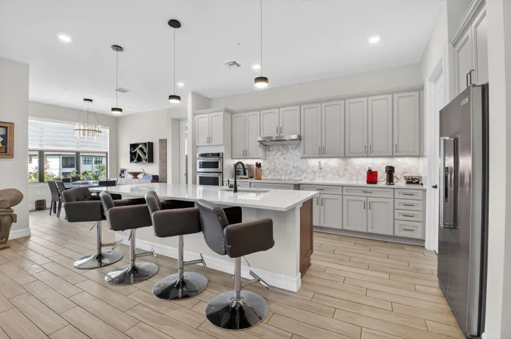 Oversized kitchen with walk-in pantry, 42" cabinets, KitchenAid appliances, quartz countertops, and much more!