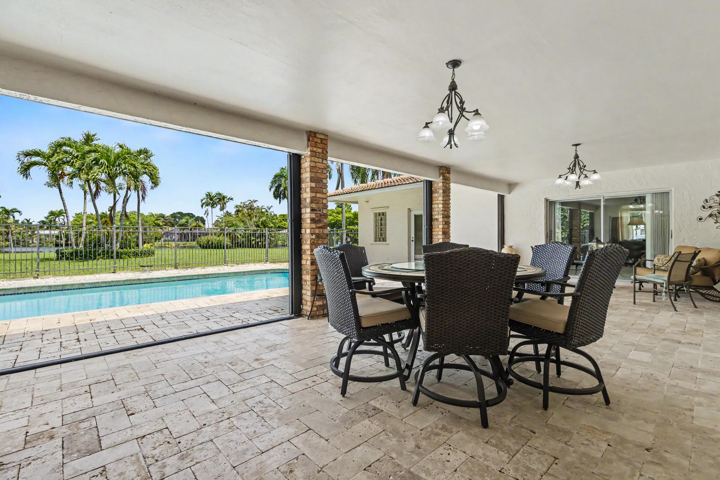 Spacious covered open patio complete with Accordion hurricane shutters