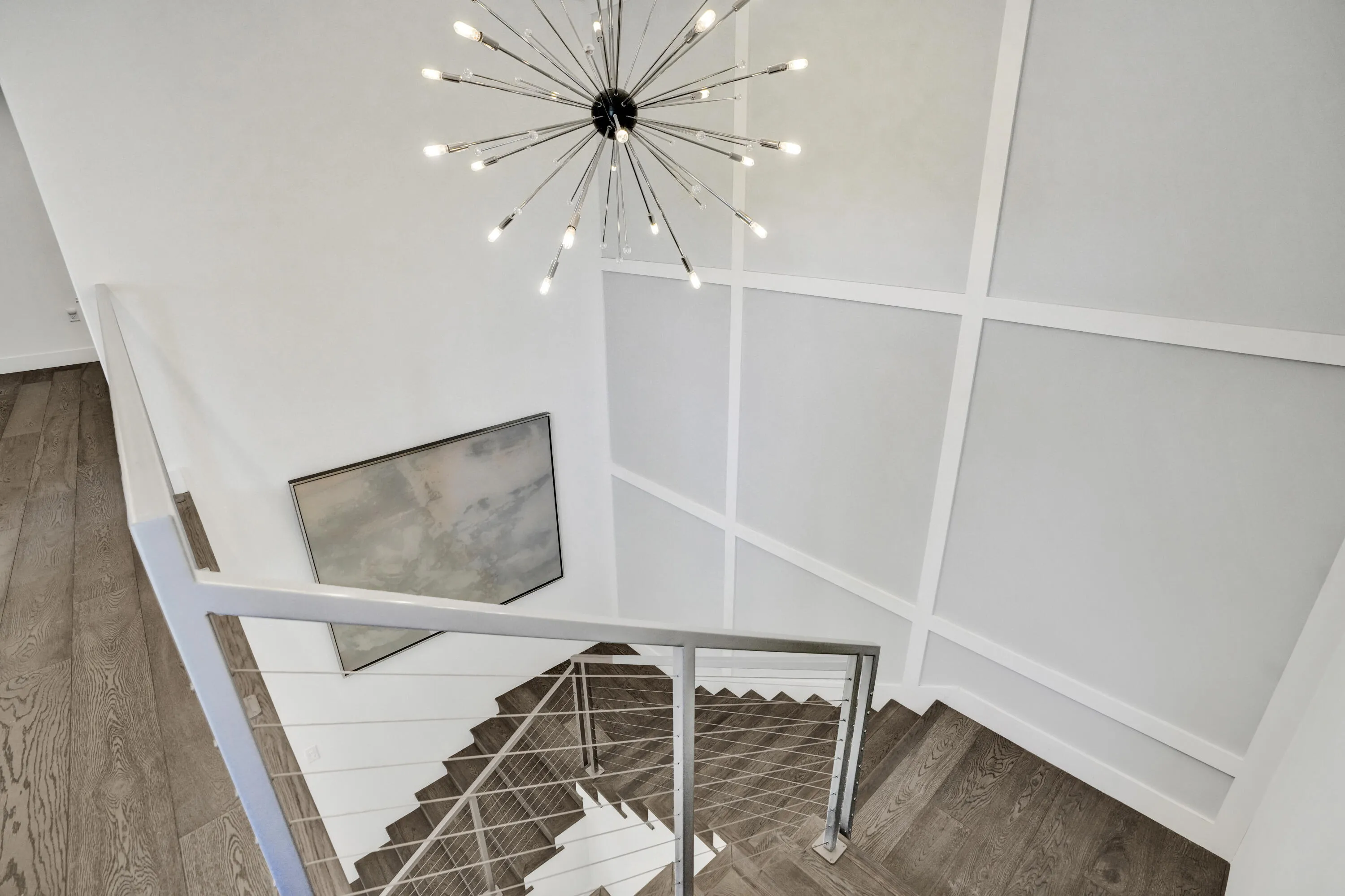 Beautiful lighting and custom woodwork in stairwell.
