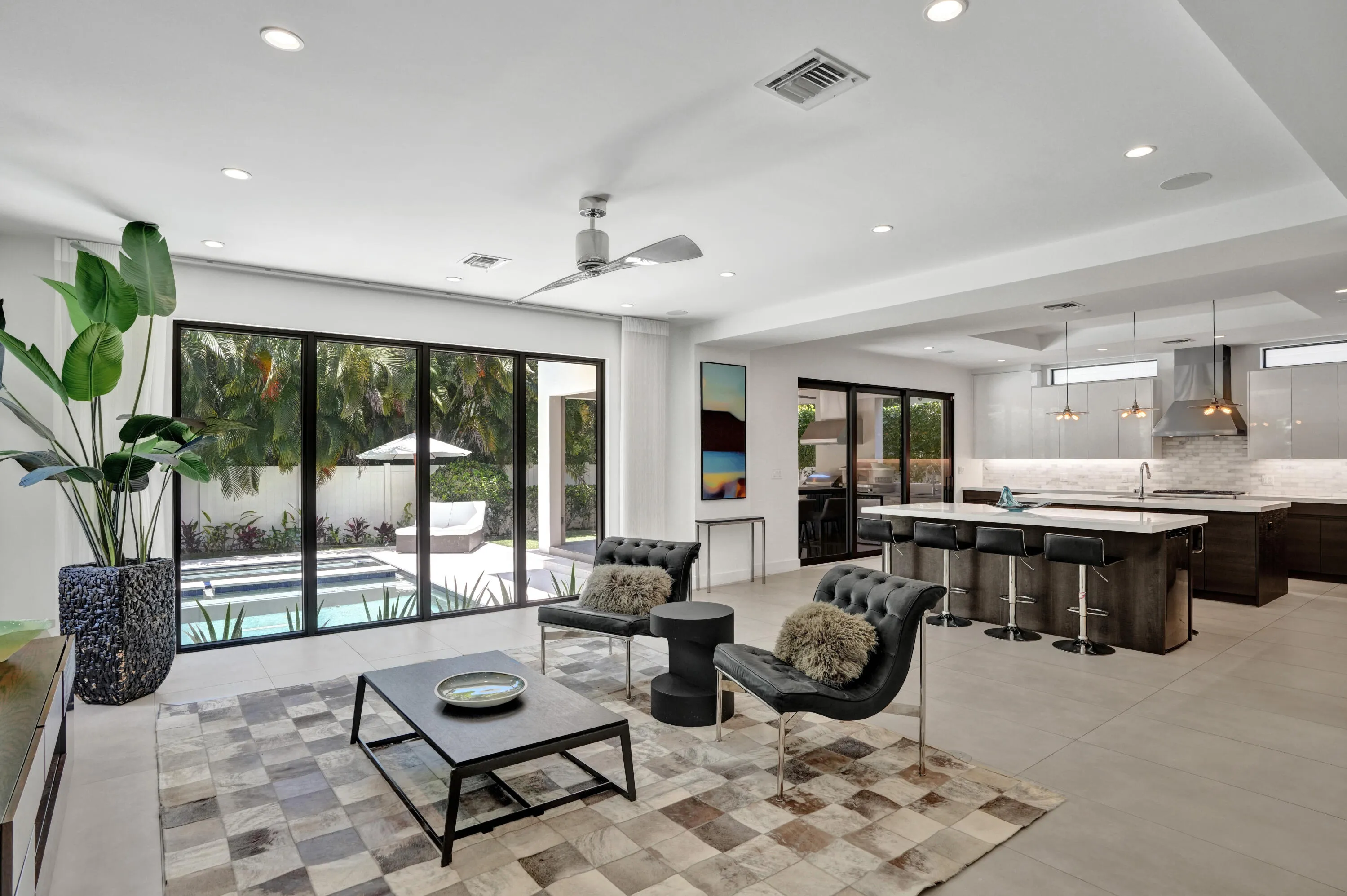 Open living room kitchen with pool views.