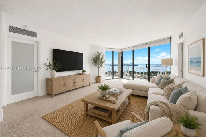 DIGITALLY STAGED LIVING ROOM WITH ENTRANCE INTO PRIMARY BEDROOM