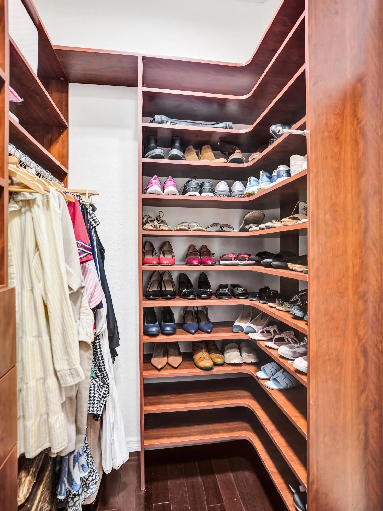 Primary walk in closets with custom cabinetry