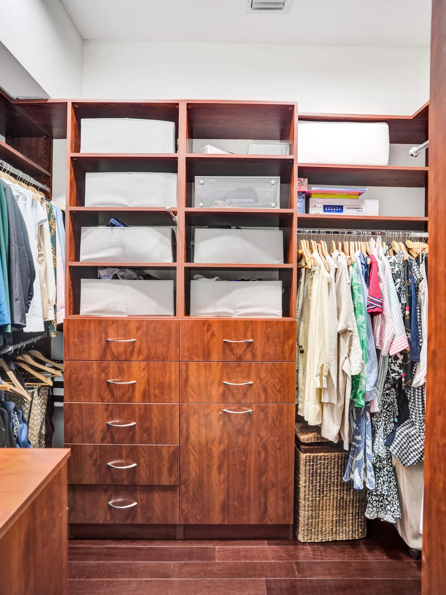 Primary walk in closets with custom cabinetry