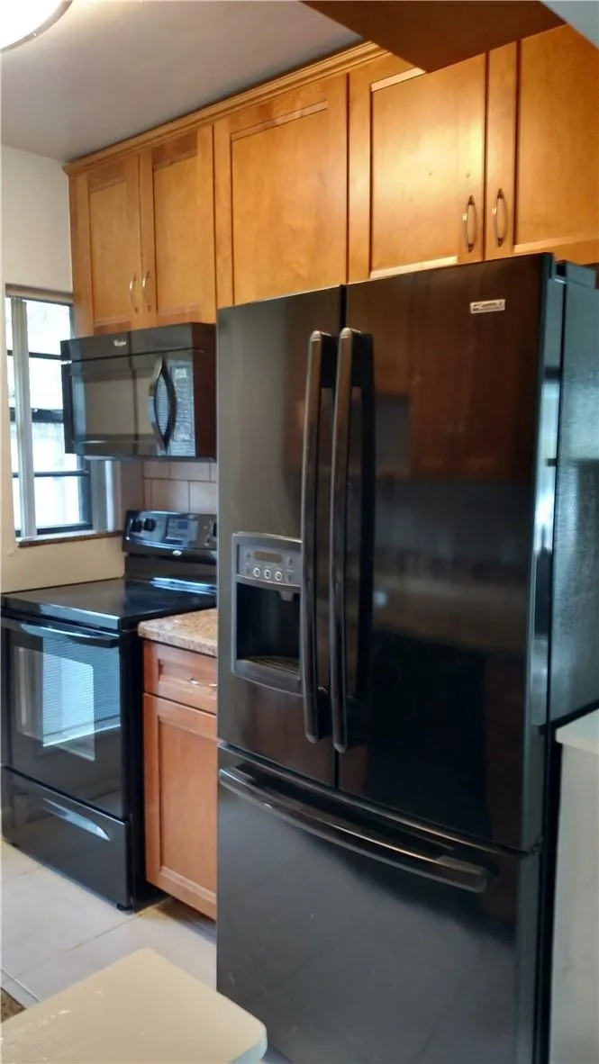 Kitchen with granite counters and wooden self close cabinets