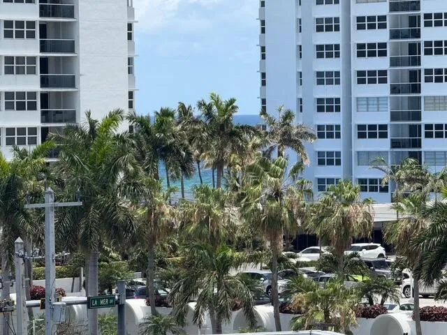View of the Ocean in between Palm trees from the Balcony