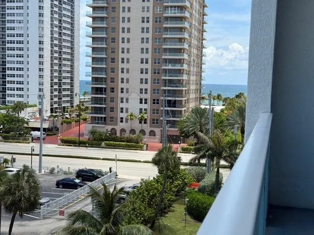 See the ocean in between buildings from the balcony