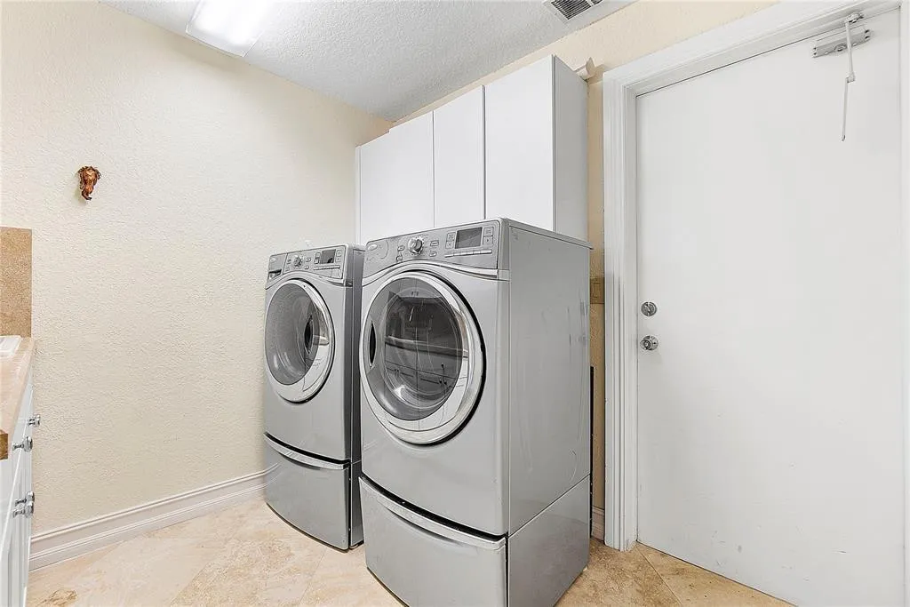 Large laundry room with utility sink.