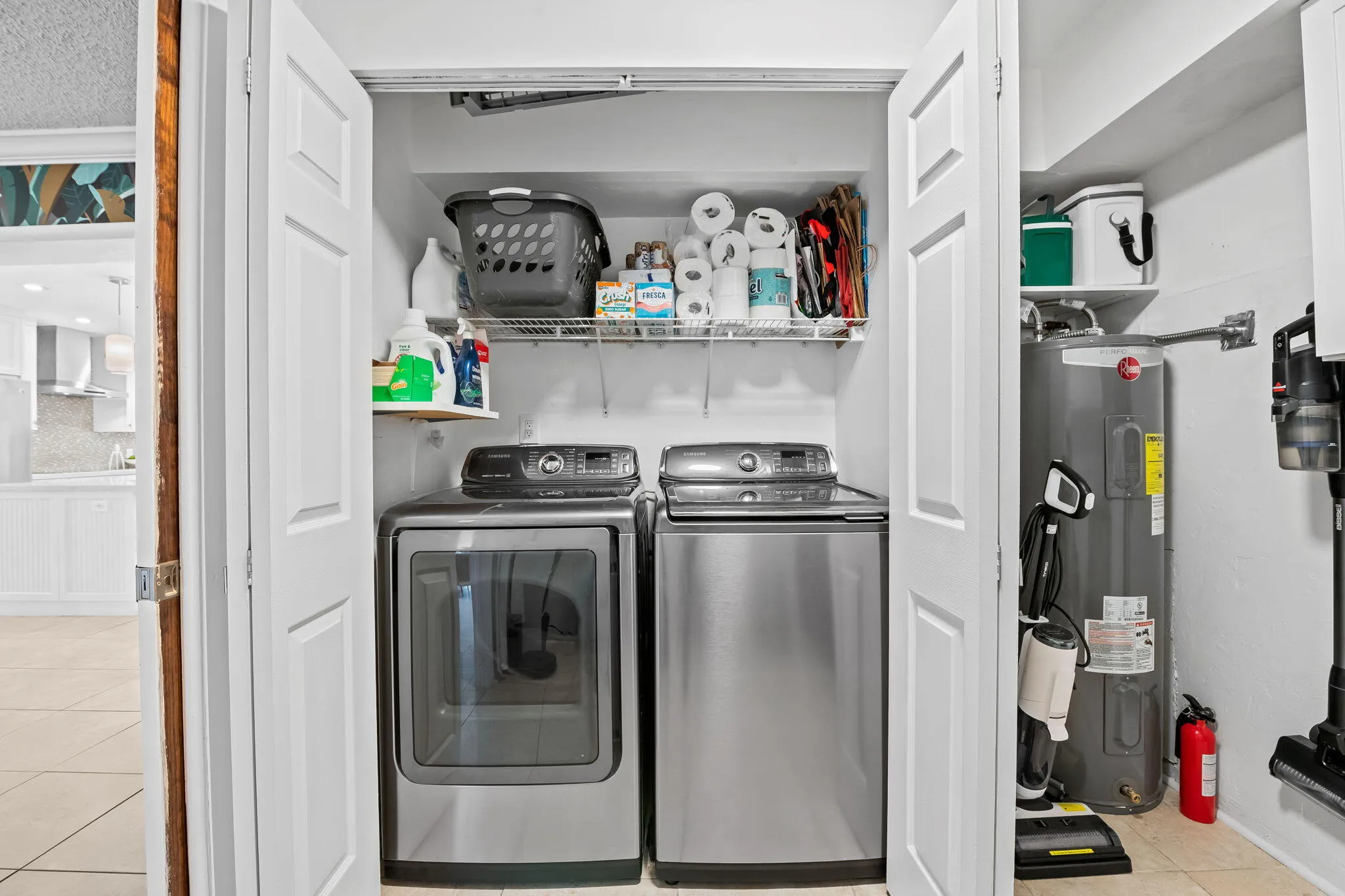Full size washer and dryer in laundry room and storage.