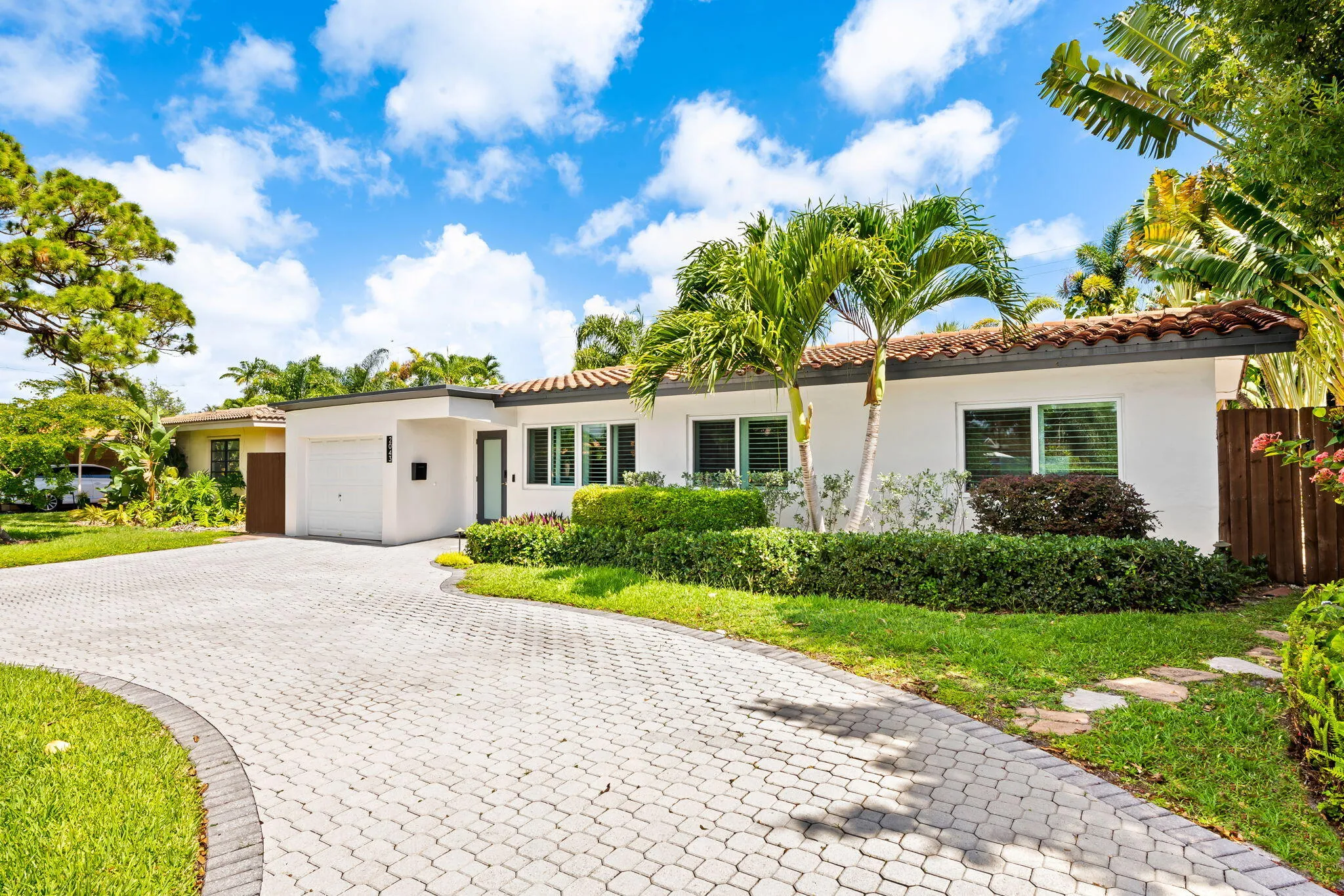 Front exterior with circular paver driveway.