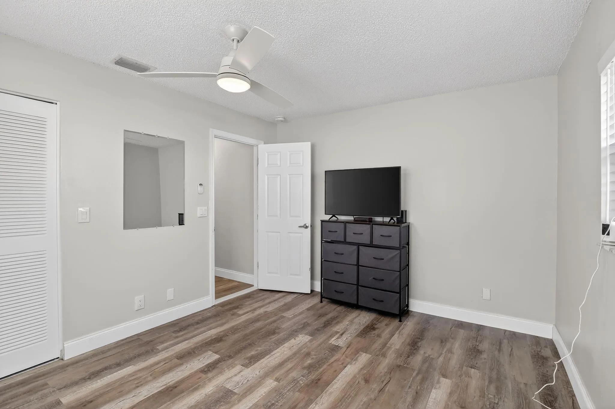 This bedroom boasts a walk in closet for extra storage.