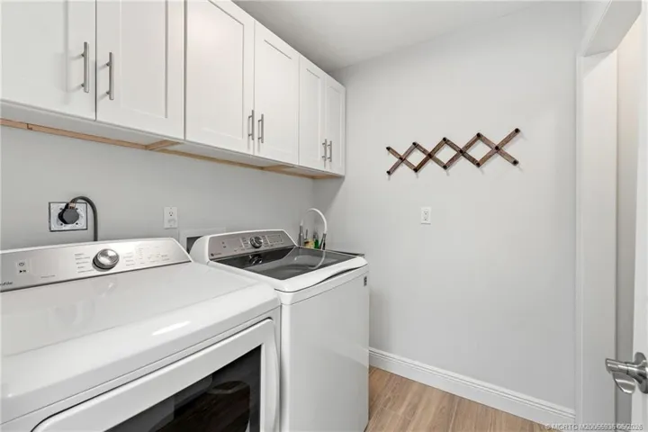 Laundry room with sink and storage.