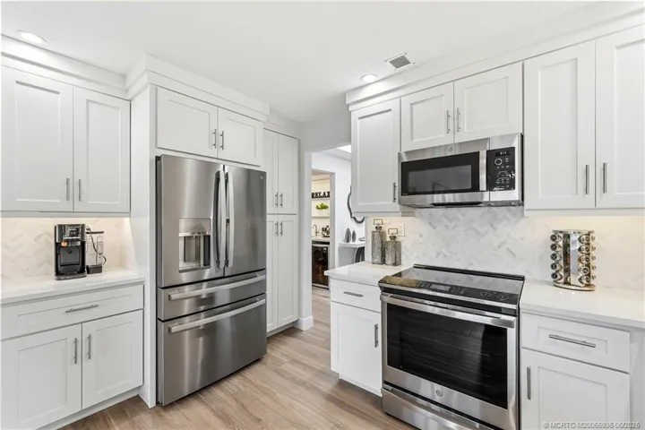 Kitchen with quartz counters and soft close cabinetry.