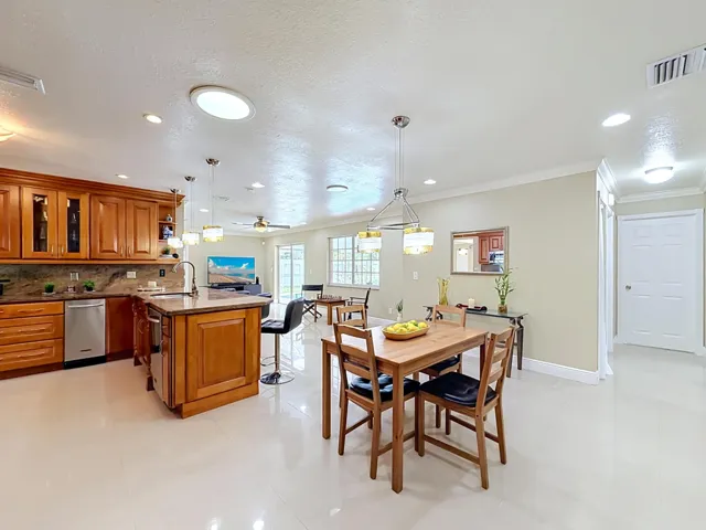 Casual dining with kitchen and family room views. Split floor plan with hallway leading to three bedrooms for added privacy.