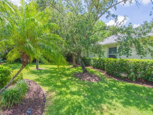 Manicured lawn with mature trees and lush landscaping