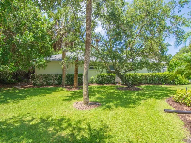 Manicured lawn with mature trees and lush landscaping