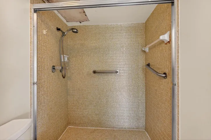 Ceiling on the left -on top of shower fixture- had a leak that was fixed according to owner. Same drywall piece was patched back on after repair.