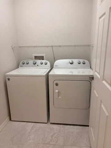 inside laundry room with shelf