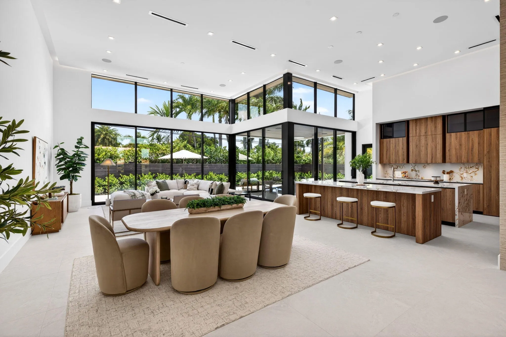 Light-filled interiors emphasize dramatic volume, clean modern finishes, and a seamless connection between living and entertaining spaces.