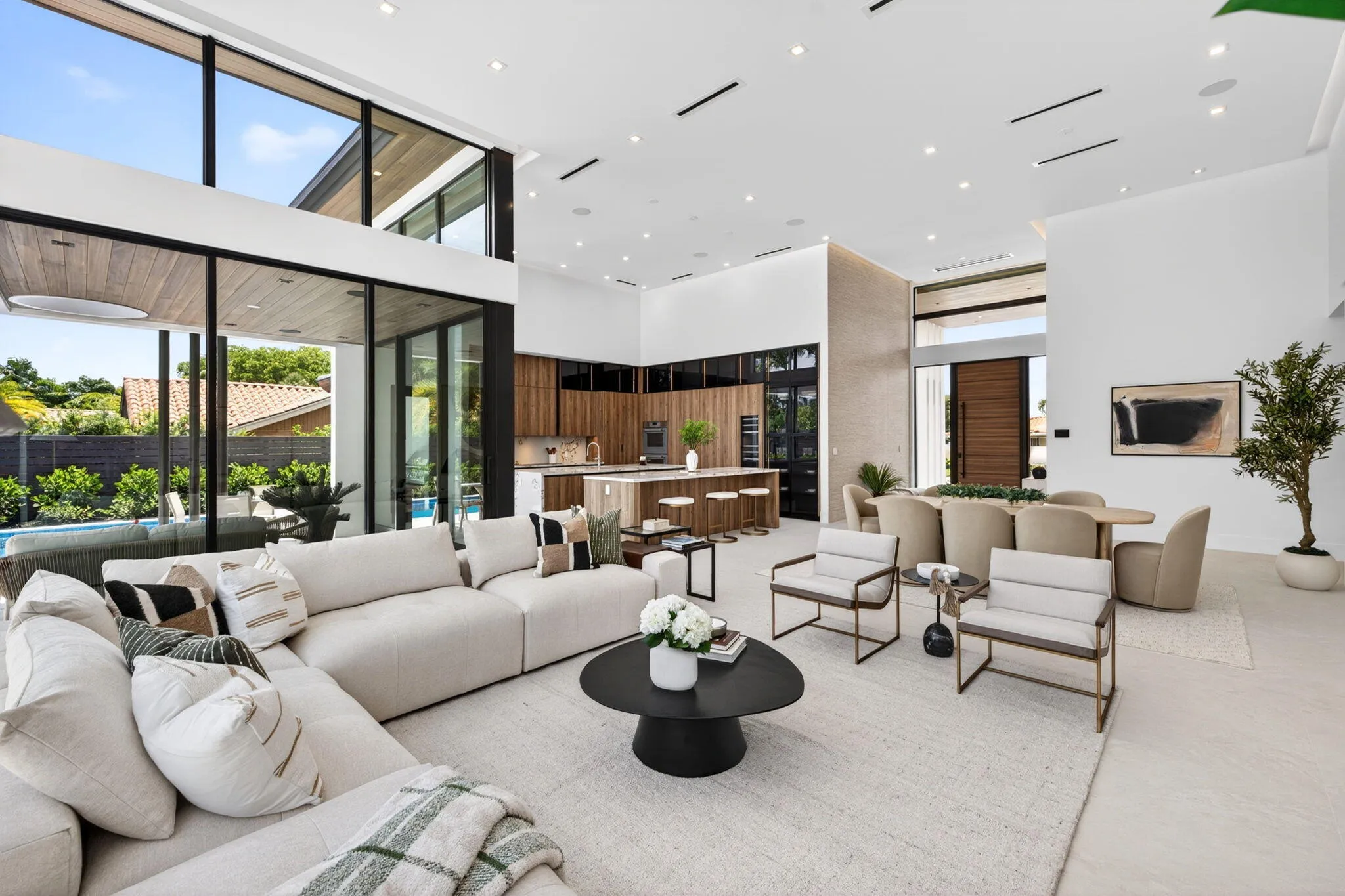 An open interior perspective captures the home's airy scale, refined material palette, and effortless single-story living.