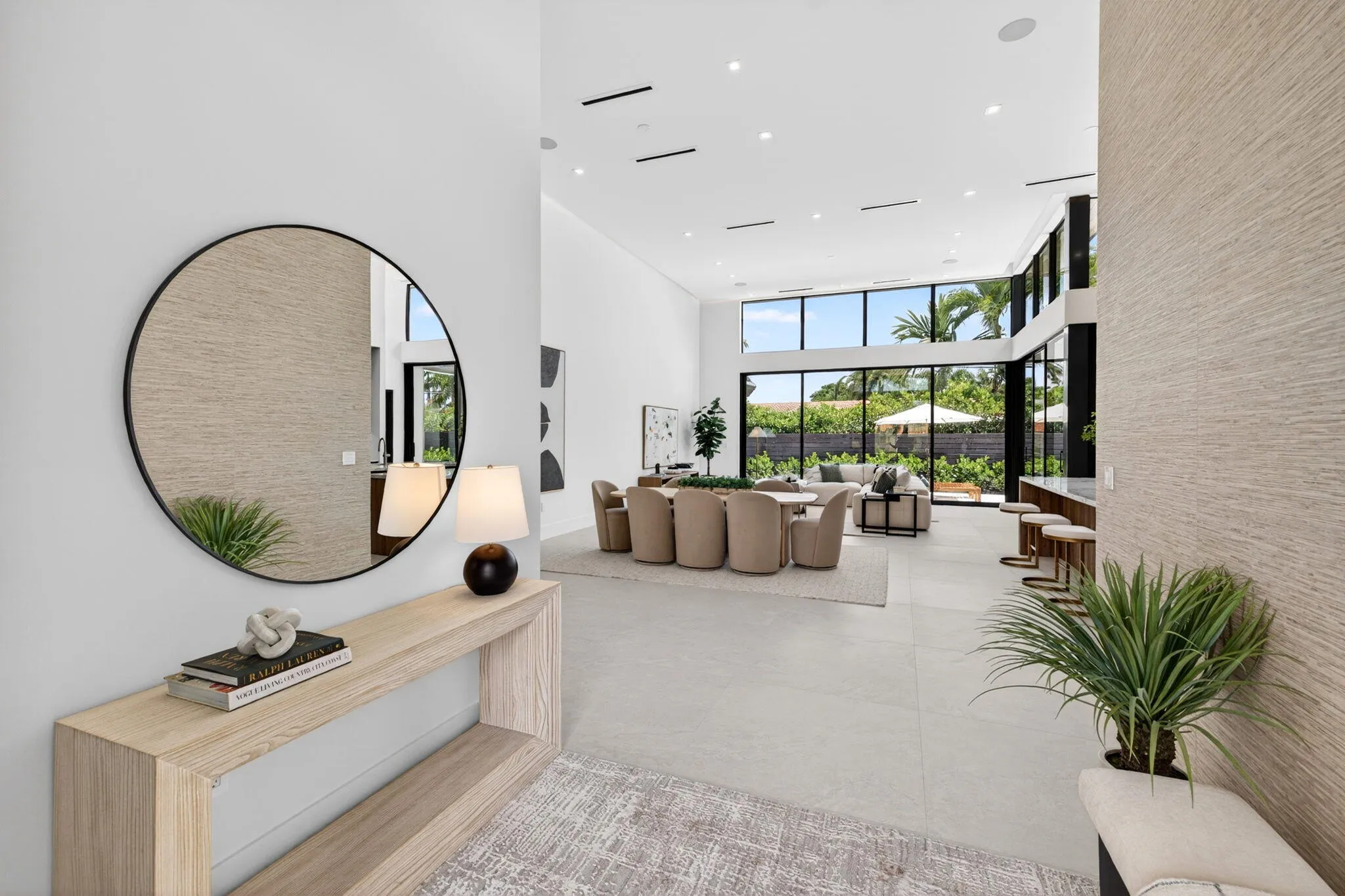 An open interior perspective captures the home's airy scale, refined material palette, and effortless single-story living.