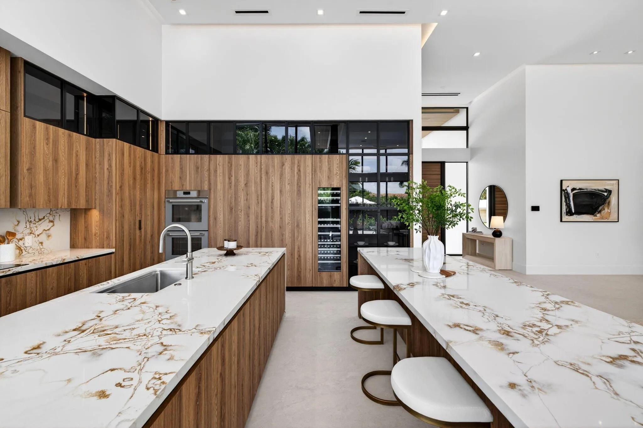 The double-island kitchen anchors the home with Italian custom cabinetry, Thermador appliances, and sophisticated entertaining space.