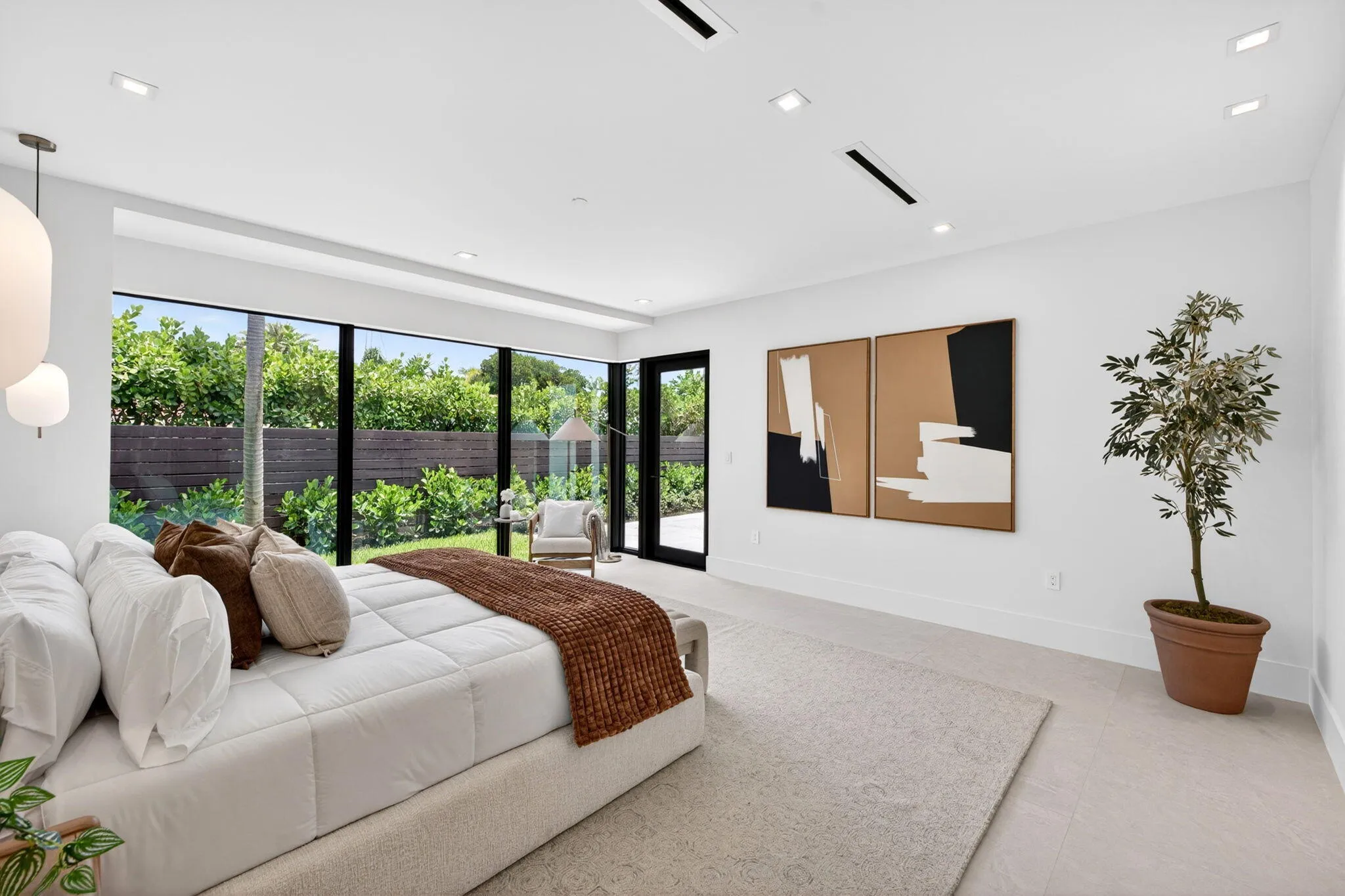 The primary suite offers a serene retreat with garden views, soft natural light, and a calm luxury sensibility.