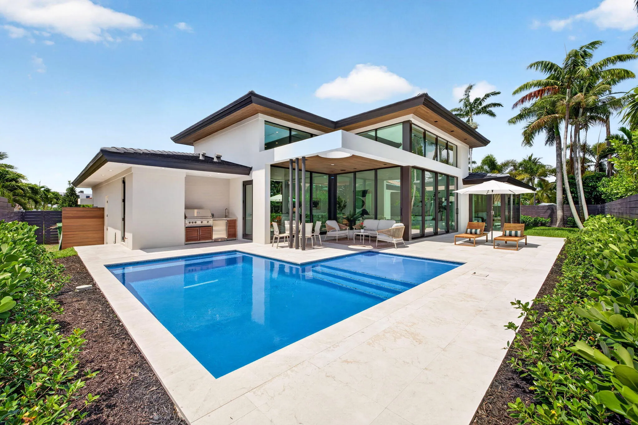 A clean-lined pool anchors the outdoor lifestyle with generous deck space, privacy, and effortless entertaining potential.