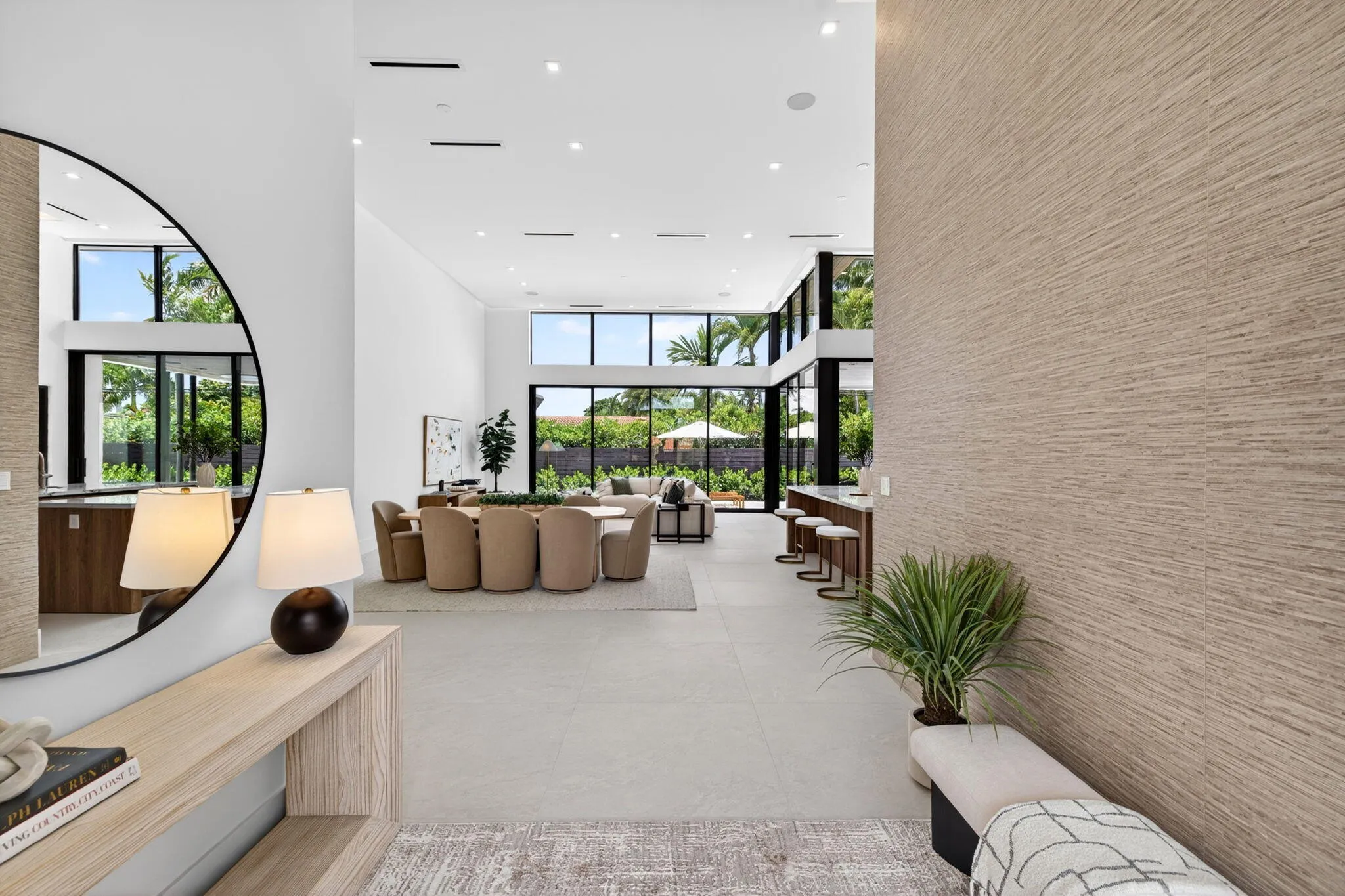 A polished arrival view showcasing the home's new construction presence, tropical landscaping, and clean Coral Ridge architecture.