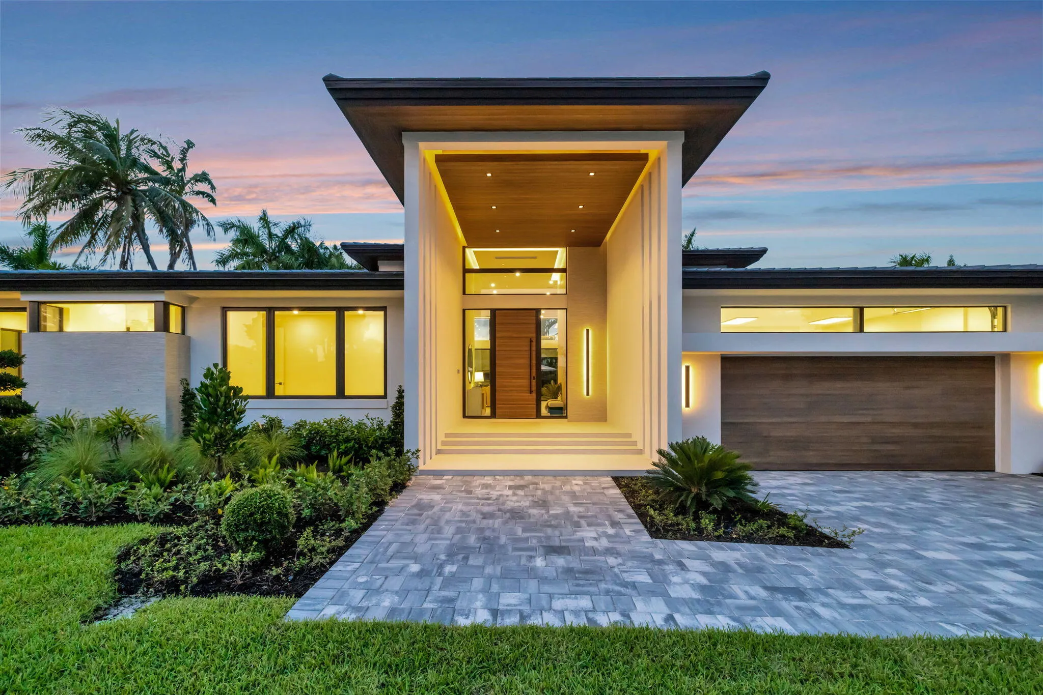 Modern single-story architecture creates strong curb appeal with a refined entry sequence and manicured Fort Lauderdale setting.